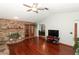 Living area with hardwood floors, fireplace and view into dining area at 2037 Apricot Dr, Deltona, FL 32725