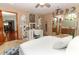 Main bedroom with vanity, en-suite bathroom access and hardwood floors at 2037 Apricot Dr, Deltona, FL 32725