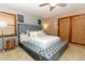 Main bedroom with a tufted gray bed and en-suite bathroom at 2037 Apricot Dr, Deltona, FL 32725