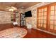Sunroom with hardwood floors, brick walls, and a ceiling fan at 2037 Apricot Dr, Deltona, FL 32725