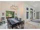 Elegant dining room with large table, chandelier, and window overlooking the garden at 35635 High Pines Dr, Eustis, FL 32736