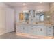 Modern bathroom with double sinks, white cabinets, and marble flooring at 35635 High Pines Dr, Eustis, FL 32736