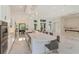 Open concept kitchen with large island, marble countertops, and a view into the adjacent living area at 35635 High Pines Dr, Eustis, FL 32736