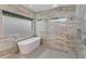 Spa-like bathroom featuring a soaking tub, walk-in shower, and marble walls at 35635 High Pines Dr, Eustis, FL 32736