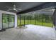 Relaxing screened porch with marble tile flooring and a ceiling fan at 35635 High Pines Dr, Eustis, FL 32736