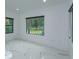 Bedroom with large windows and marble floors at 35635 High Pines Dr, Eustis, FL 32736