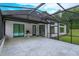 Large screened patio with marble tile, offering views of the backyard at 35635 High Pines Dr, Eustis, FL 32736