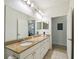 Elegant bathroom with double vanity and large mirror at 200 Southern Pecan Cir # 105, Winter Garden, FL 34787