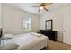 Well-lit bedroom featuring a double bed, dresser, and carpet flooring at 200 Southern Pecan Cir # 105, Winter Garden, FL 34787