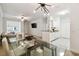 Open concept dining area with glass table and kitchen access at 200 Southern Pecan Cir # 105, Winter Garden, FL 34787