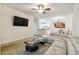 Living room with sectional sofa, coffee table, and view of kitchen and dining area at 200 Southern Pecan Cir # 105, Winter Garden, FL 34787