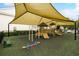 Shaded playground with modern equipment and safety surfacing at 200 Southern Pecan Cir # 105, Winter Garden, FL 34787