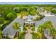Aerial view of community entrance and buildings with lush landscaping and pool at 200 Southern Pecan Cir # 105, Winter Garden, FL 34787