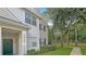 Two-story townhouse with green door and manicured lawn at 200 Southern Pecan Cir # 105, Winter Garden, FL 34787