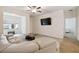 Bright living room with sectional sofa, coffee table, and view of entryway at 200 Southern Pecan Cir # 105, Winter Garden, FL 34787