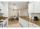 Bright kitchen with granite countertops and stainless steel appliances at 200 Southern Pecan Cir # 105, Winter Garden, FL 34787
