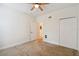 Well-lit bedroom with ceiling fan and double closets at 200 Southern Pecan Cir # 105, Winter Garden, FL 34787