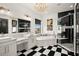 Luxurious bathroom featuring a soaking tub, double vanity, and checkered floor at 4029 Isabella Cir, Windermere, FL 34786