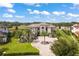 Luxury home with a circular driveway and lush landscaping at 4029 Isabella Cir, Windermere, FL 34786