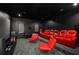 Upscale home theater with red leather seating, large screen, and surround sound at 4029 Isabella Cir, Windermere, FL 34786
