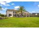 Luxury home with expansive backyard, pool, and palm trees at 4029 Isabella Cir, Windermere, FL 34786