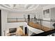 Elegant upper landing with hardwood floors and modern metal railing overlooks the grand entry at 4029 Isabella Cir, Windermere, FL 34786