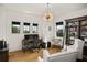 Bright home office with built-in shelving, large windows, and hardwood floors at 4029 Isabella Cir, Windermere, FL 34786