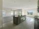 Open kitchen with island, granite countertops, and stainless steel appliances at 3696 Sagefield Dr, St Cloud, FL 34773