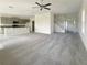 Open-concept living room with high ceilings, grey carpet, and kitchen views at 3696 Sagefield Dr, St Cloud, FL 34773