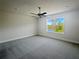 Spacious bedroom with a large window and carpet flooring at 3696 Sagefield Dr, St Cloud, FL 34773