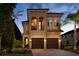 Two-story house with a two-car garage and balcony at 860 Desert Mountain Ct, Reunion, FL 34747