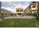 Landscaped backyard view of two-story home with a patio and pool beyond at 860 Desert Mountain Ct, Reunion, FL 34747