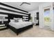 Bedroom with black and white striped wall and king-size bed at 860 Desert Mountain Ct, Reunion, FL 34747