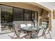 Covered patio with outdoor dining set and built-in grill at 860 Desert Mountain Ct, Reunion, FL 34747