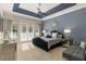 Spacious main bedroom with a king-size bed and access to a private balcony at 860 Desert Mountain Ct, Reunion, FL 34747