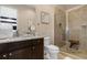 Bathroom with granite countertop, toilet, and glass-enclosed shower at 860 Desert Mountain Ct, Reunion, FL 34747