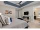Spacious main bedroom with ensuite bathroom access and tray ceiling at 860 Desert Mountain Ct, Reunion, FL 34747