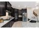 Spacious kitchen featuring dark wood cabinets, granite counters, and stainless steel appliances at 860 Desert Mountain Ct, Reunion, FL 34747