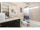 Bathroom with granite vanity, bathtub, and superhero-themed decor at 860 Desert Mountain Ct, Reunion, FL 34747