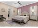 Luxurious main bedroom with a king-size bed and ensuite bathroom access at 860 Desert Mountain Ct, Reunion, FL 34747