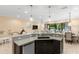 Kitchen island with granite countertop, sink, and dishwasher, open to living and dining areas at 860 Desert Mountain Ct, Reunion, FL 34747