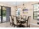Bright dining area with a large table, chairs, and stylish light fixtures near sliding doors at 860 Desert Mountain Ct, Reunion, FL 34747