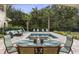 Outdoor patio with dining set, pool view, and lush landscaping at 860 Desert Mountain Ct, Reunion, FL 34747