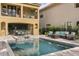 Resort-style pool and spa with patio furniture, adjacent to a beautiful two-story home at 860 Desert Mountain Ct, Reunion, FL 34747