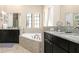 Bathroom with granite countertops, corner bathtub, and dark wood cabinets at 860 Desert Mountain Ct, Reunion, FL 34747
