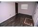 Simple living room with dark grey vinyl flooring and a small area rug at 1879 Lake Emma Rd, Longwood, FL 32750
