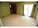 Simple bedroom with neutral walls and carpeted floors; access to a sliding door at 1879 Lake Emma Rd, Longwood, FL 32750
