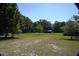 Large backyard with mature trees and a grassy area at 1879 Lake Emma Rd, Longwood, FL 32750