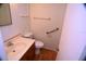 Clean bathroom includes a toilet, sink, and grab bar at 1879 Lake Emma Rd, Longwood, FL 32750