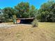 Open-air storage shed with a metal roof and concrete floor at 1879 Lake Emma Rd, Longwood, FL 32750
